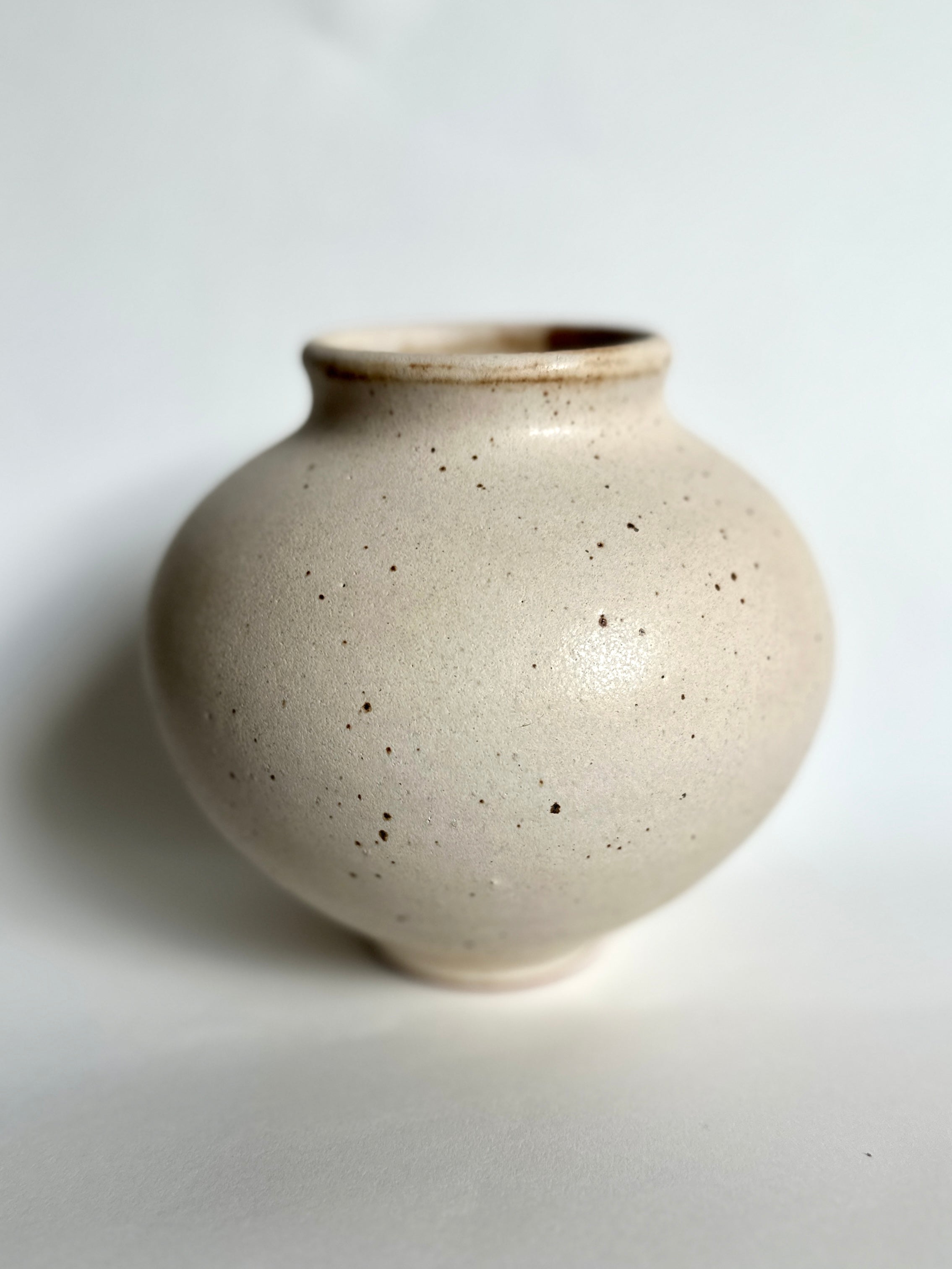 Warm satin white speckled vase