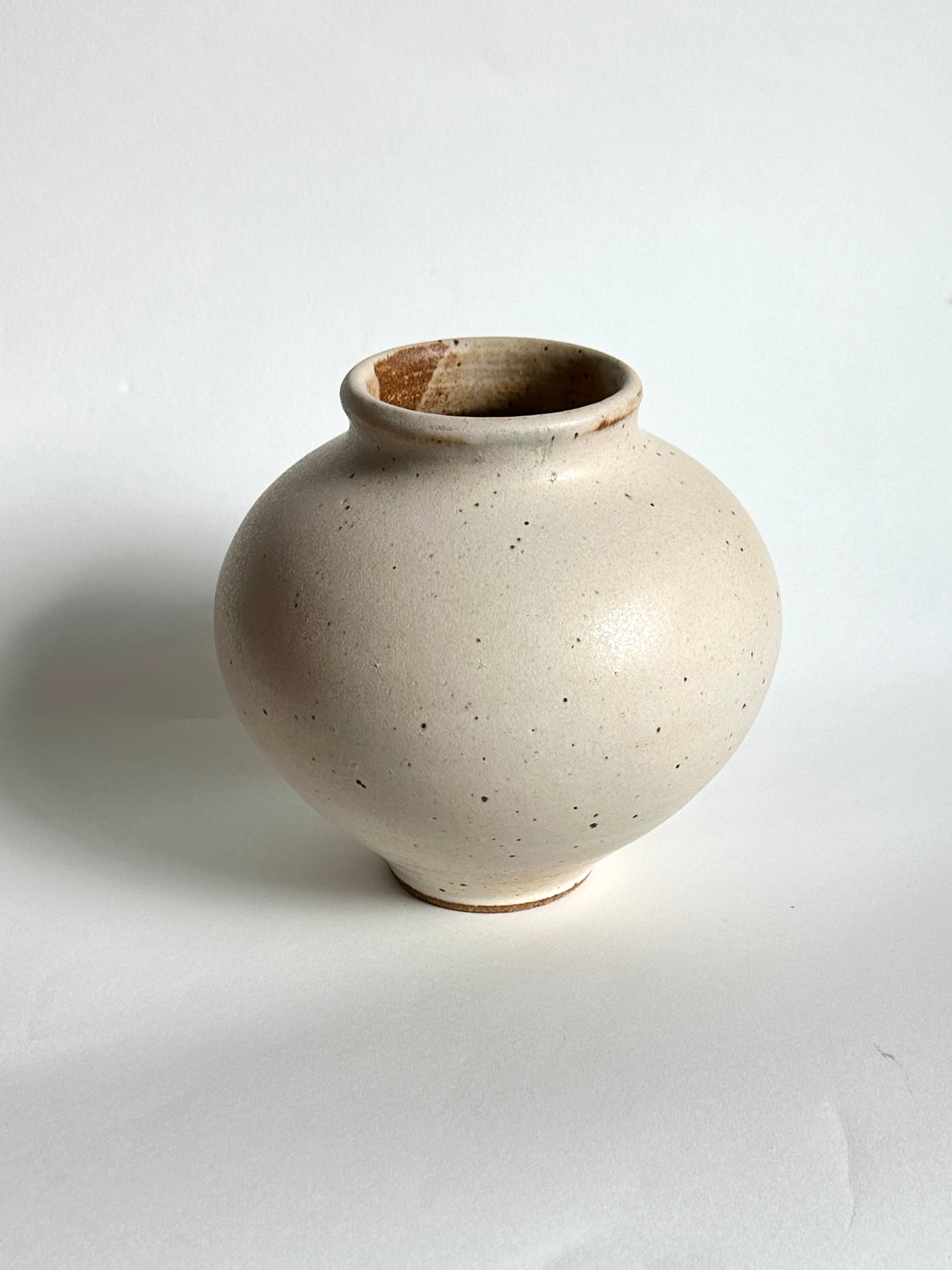 Warm satin white speckled vase