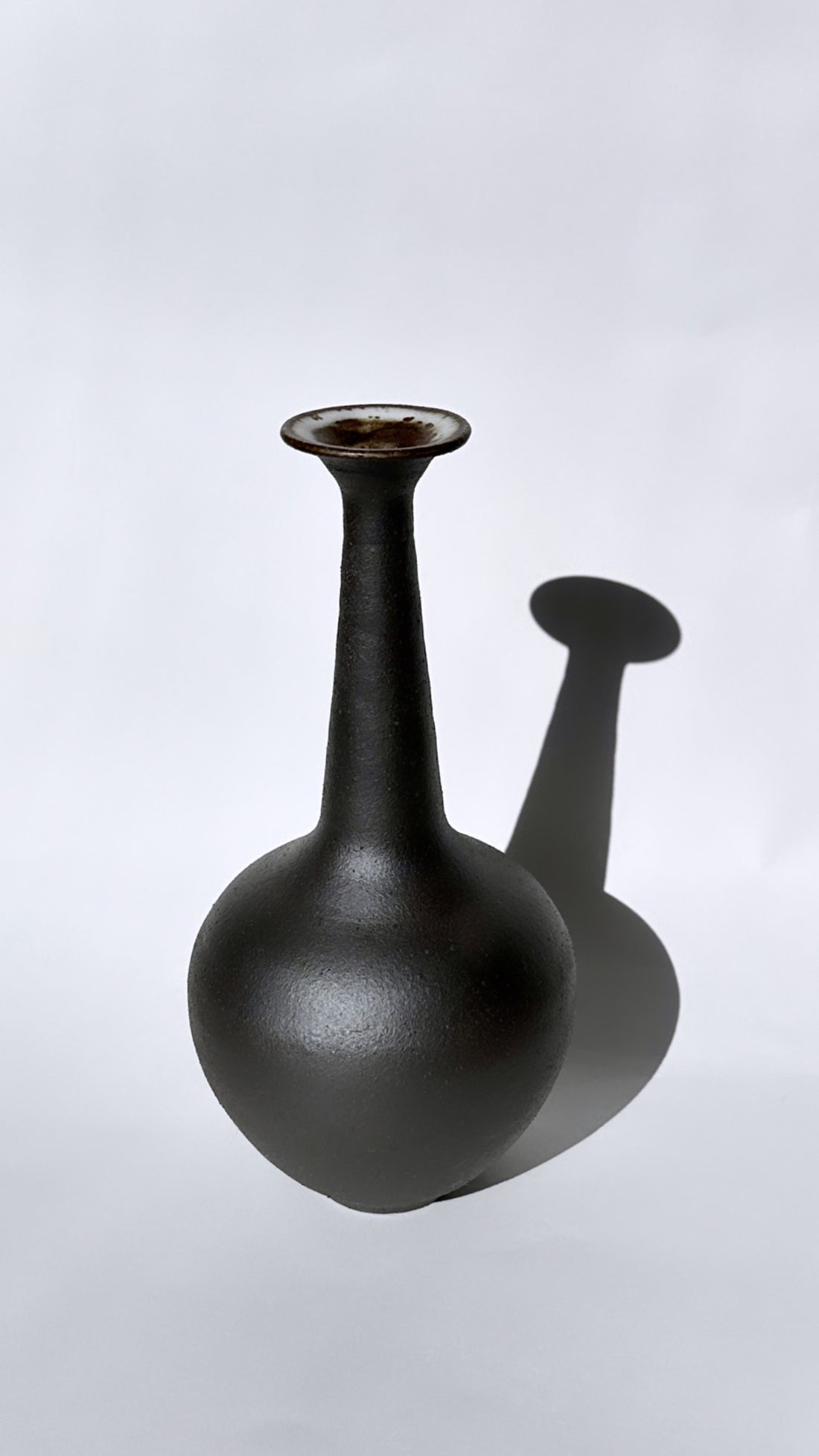 Black clay tall flared bottleneck no. 12